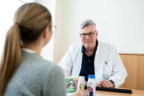 Eine Patientin im Gespräch mit einem Arzt der Onkologie Darmstadt.